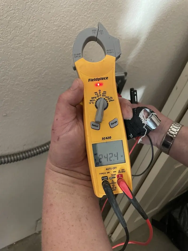 Voltage testing with clamp meter during Circuit Breaker Repair in Brick